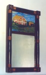 Painted pine mirror in the American Empire style with reverse painting on glass