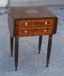Mahogany late Sheraton style drop-leaf table made of mahogany and inlaid with satinwood and rosewood